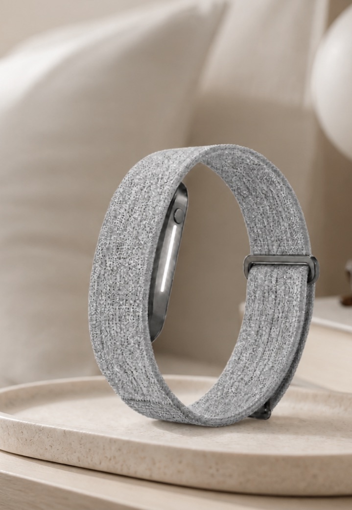 A Haven band resting on a ceramic tray on a bedside table