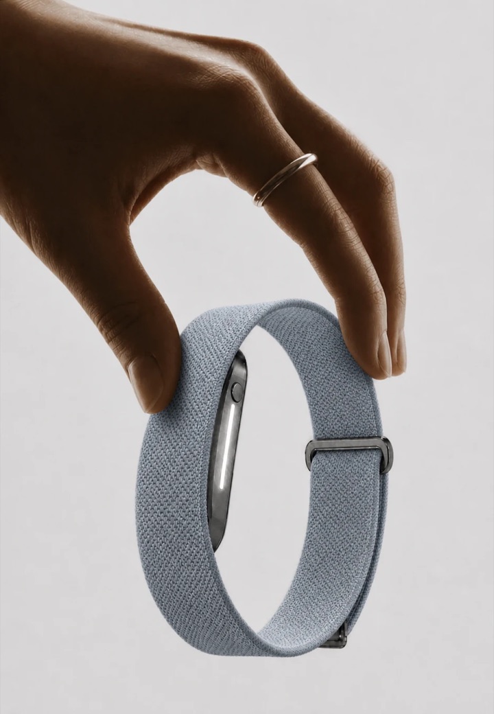 A hand picking up a Haven band